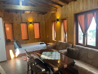 a living room with a couch and a bed and a table at Studio Elias in Zlatograd