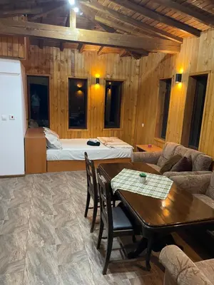 a living room with a bed and a table and chairs at Studio Elias in Zlatograd