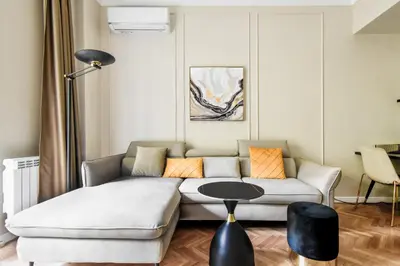 a living room with a couch and a table at Designer 2BD Apt Near Alexander Nevski Cathedral by Flat Mаnager in Sofia