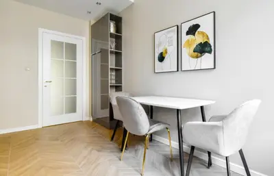 a dining room with a white table and chairs at Designer 2BD Apt Near Alexander Nevski Cathedral by Flat Mаnager in Sofia
