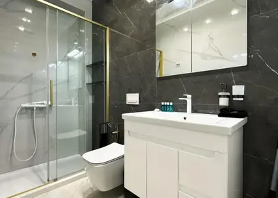 a bathroom with a toilet and a sink and a shower at Designer 2BD Apt Near Alexander Nevski Cathedral by Flat Mаnager in Sofia
