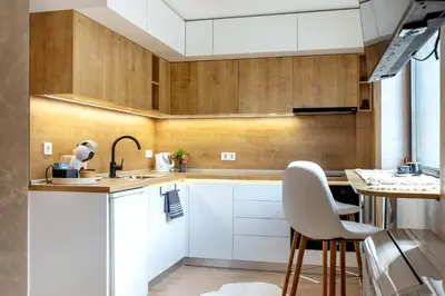 a kitchen with white cabinets and a table at Iva's Dream Studio, Crafted with Love and Passion in Bansko