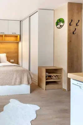 a small bedroom with a bed and a table at Iva's Dream Studio, Crafted with Love and Passion in Bansko