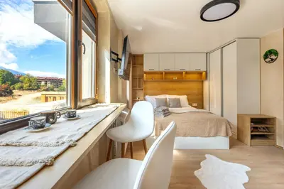 a bedroom with a bed and a large window at Iva's Dream Studio, Crafted with Love and Passion in Bansko