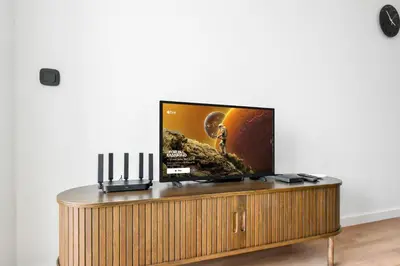 a flat screen tv sitting on top of a wooden table at Modern & Quiet 1BR Near Center by Flat Mаnager in Sofia