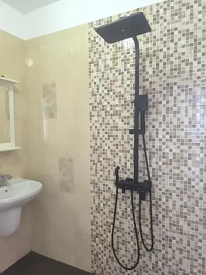 a shower with a shower head in a bathroom at Sunny Hollow in Sofia