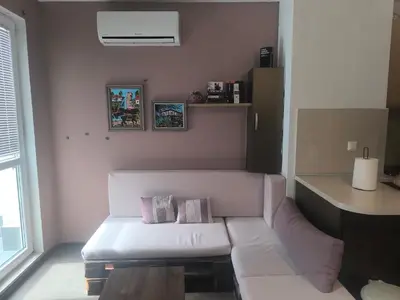 a living room with a white couch with two pillows at Sunny Hollow in Sofia