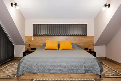 a bedroom with a large bed with yellow pillows at Вила Тих кът in Resilovo