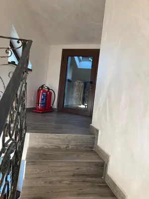 a stairway leading to a room with a door at Вила Тих кът in Resilovo