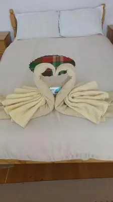 a bed with two towels on it with at Guest House Jani in Trigrad