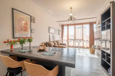 a living room with a large table and chairs at Cozy Studio in Sofia