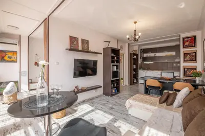 a living room with a couch and a table at Cozy Studio in Sofia