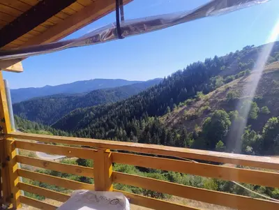 a view of the mountains from the porch of a house at Къща Сливови in Bŭnzareto