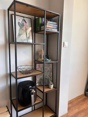 a black book shelf with a tv in a room at Cozy&Quiet l 1BD l Free Parking in Sofia