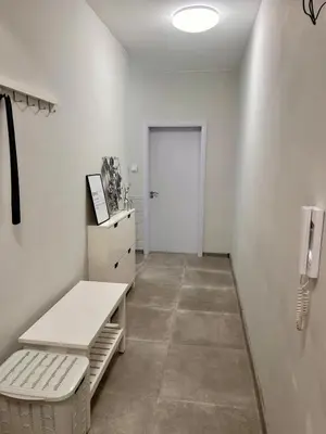 a white room with a door and a white bench at Cozy&Quiet l 1BD l Free Parking in Sofia