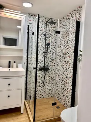 a bathroom with a shower with a glass door at Cozy&Quiet l 1BD l Free Parking in Sofia