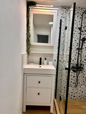 a bathroom with a white sink and a mirror at Cozy&Quiet l 1BD l Free Parking in Sofia