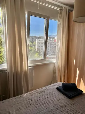 a bedroom with a bed and a large window at Cozy&Quiet l 1BD l Free Parking in Sofia