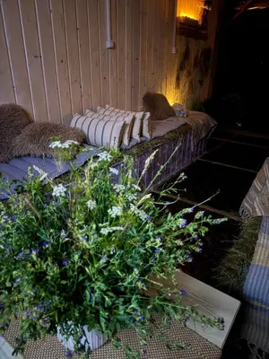 a couch with pillows on it next to a plant at Stenata LightWill in Banya