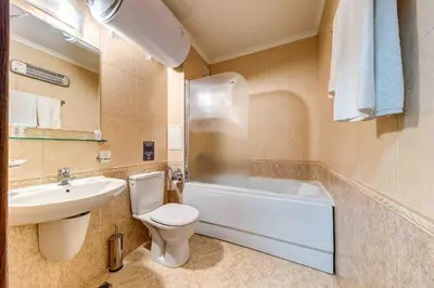 a bathroom with a toilet and a sink and a tub at Тристаен апартамент 1А17 Гранд Манастира Пампорово in Pamporovo