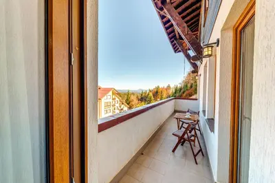 a balcony with a table and a view at Тристаен апартамент 1А17 Гранд Манастира Пампорово in Pamporovo