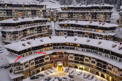 a group of buildings with snow on them at Тристаен апартамент 1А17 Гранд Манастира Пампорово in Pamporovo