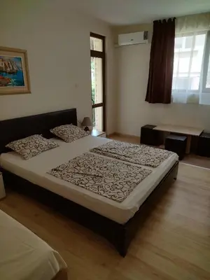 a bedroom with a large bed in a room at Къща за гости Св Никола in Tschepinzi