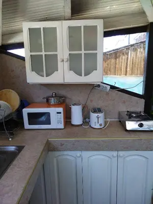 a kitchen with a counter top with a microwave at Къща за гости Св Никола in Tschepinzi