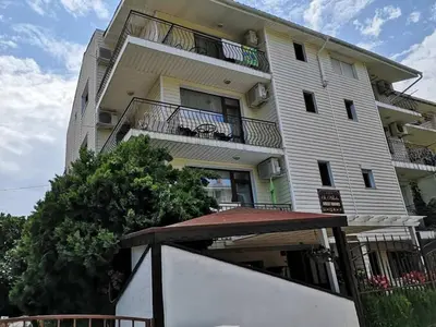 a large white building with balconies on it at Къща за гости Св Никола in Tschepinzi