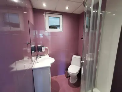 a purple bathroom with a toilet and a shower at Villa Aqua in Pravets