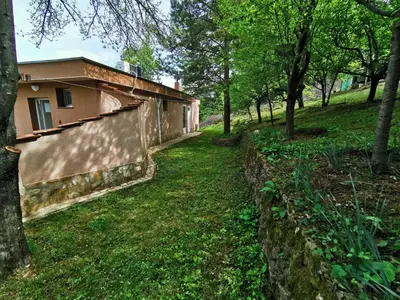 a building in a park with trees and grass at Villa Aqua in Pravets