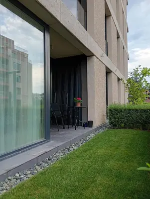 a balcony of a building with a table and chairs at Light View Apartment - New Center in Sofia