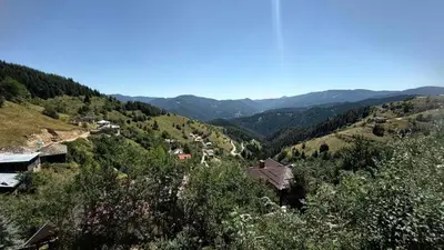 an aerial view of a mountain with houses and trees at Вила Зора in Chepelare