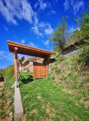 a woodenshed on the side of a hill at Вила Зора in Chepelare