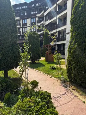 a garden in front of an apartment building at Alpine Lodge Chalet in Bansko in Bansko