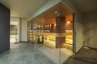 a room with a large glass wall at Bansko 1BR for 4 w Balcony View Spa Near Ski Lift in Bansko