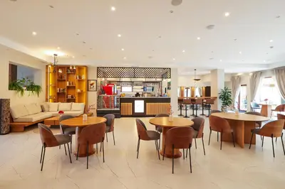 a lobby with tables and chairs and a living room at Bansko 1BR for 4 w Balcony View Spa Near Ski Lift in Bansko