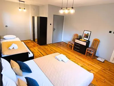 a room with two beds and a desk and chairs at City Garden - Amazing Garden for party and friends in Kostinbrod