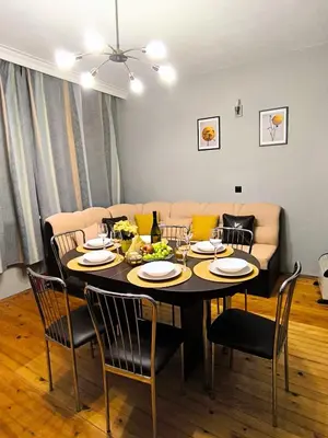 a dining room table with chairs and a couch at City Garden - Amazing Garden for party and friends in Kostinbrod