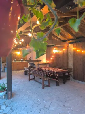a patio with two wooden benches and a table at City Garden - Amazing Garden for party and friends in Kostinbrod