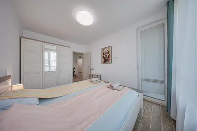 a bedroom with a large bed and a window at NOAR - Free parking - Metro access in Sofia