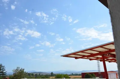 a view of a blue sky from a building at Хотел Летище Лесново in Ormanliya