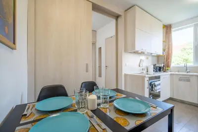 a dining room table with blue plates on it at SOFIA41 - Prime Location in Sofia
