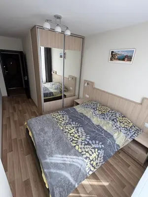 a bedroom with a bed and a large mirror at Nikea apart 2 in Velingrad