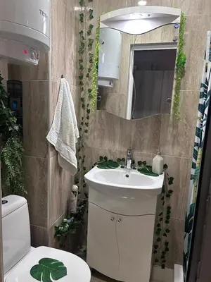 a bathroom with a sink and a toilet and a mirror at Damyanov residence in Pazardzhik