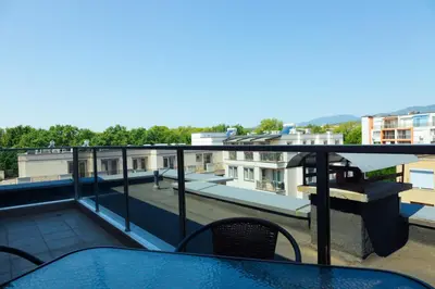a balcony with a view of a building at Просторен апартамент за семейна почивка in Hisarya