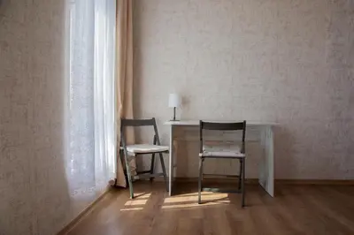 two chairs sitting at a table in a room at Просторен апартамент за семейна почивка in Hisarya