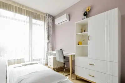 a white bedroom with a bed and a desk at Charming 2BD with Mountain View by Flat Mаnager in Sofia