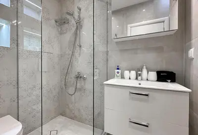 a bathroom with a shower with a toilet and a sink at Charming 2BD with Mountain View by Flat Mаnager in Sofia