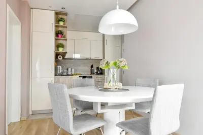 a white dining room with a white table and chairs at Charming 2BD with Mountain View by Flat Mаnager in Sofia